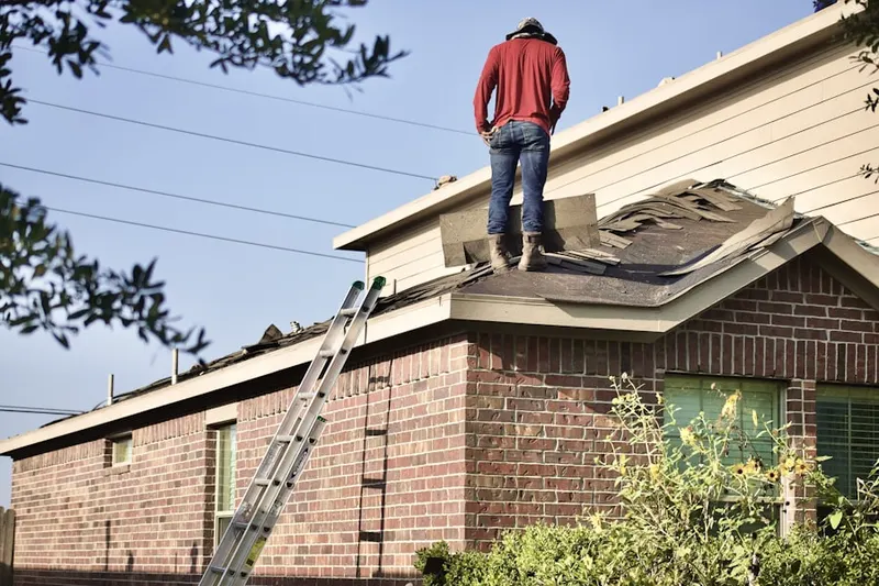 Professional roofer working on a residential roof in Delaware City